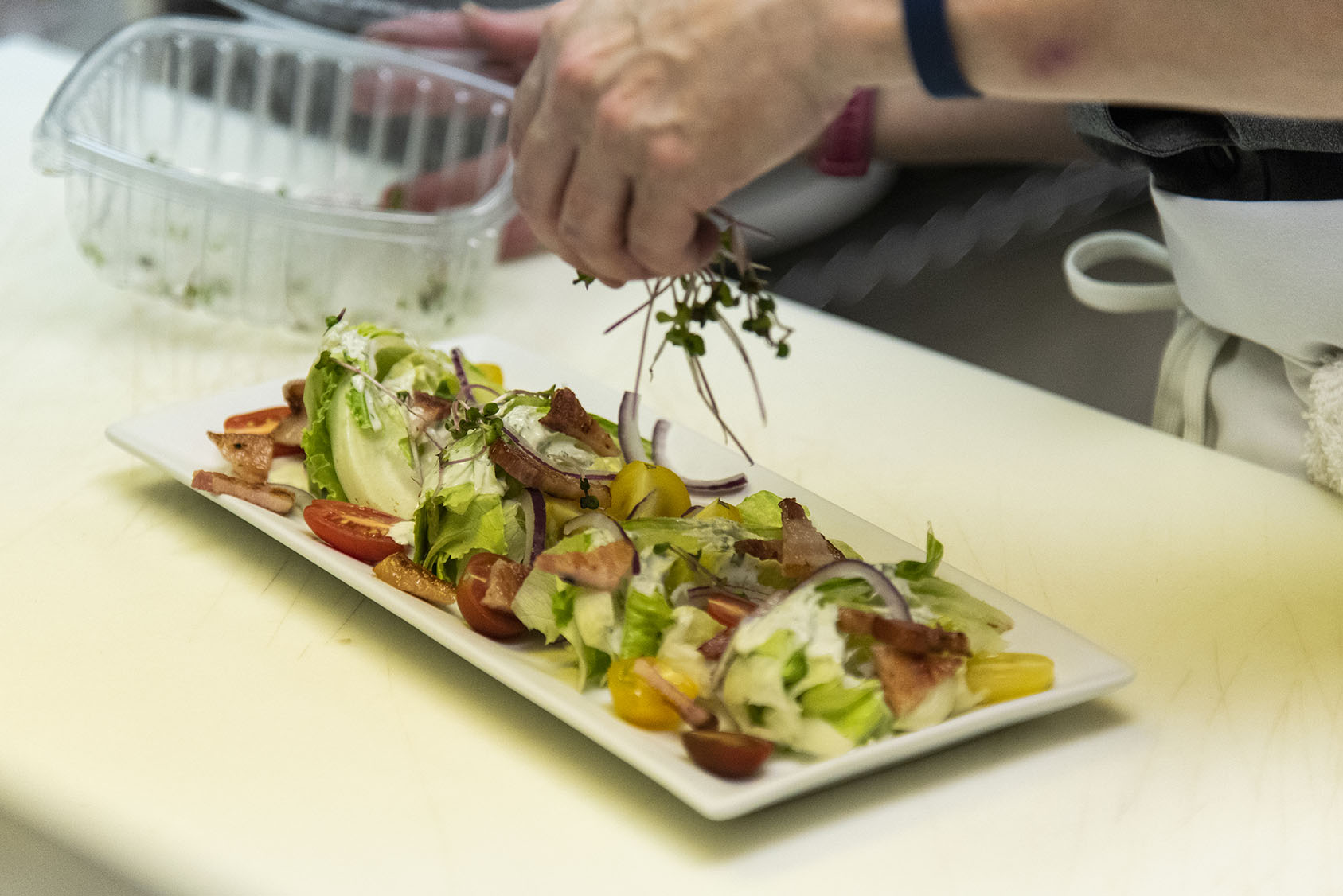 man preparing salad