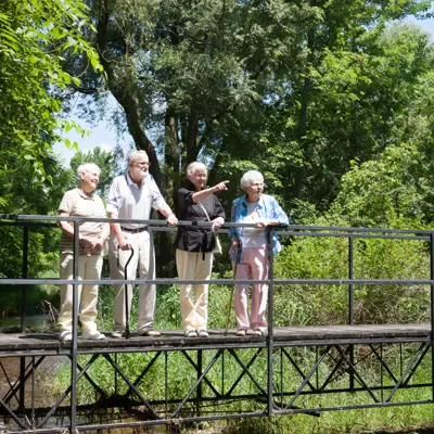 Seniors standing on a bridge